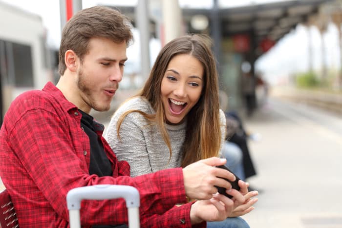 Couple playing games on a smartphone and finding ways to get free steam wallet codes